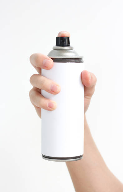istock Man's hand holds a spray of black paint. Isolated on a white background 669541600