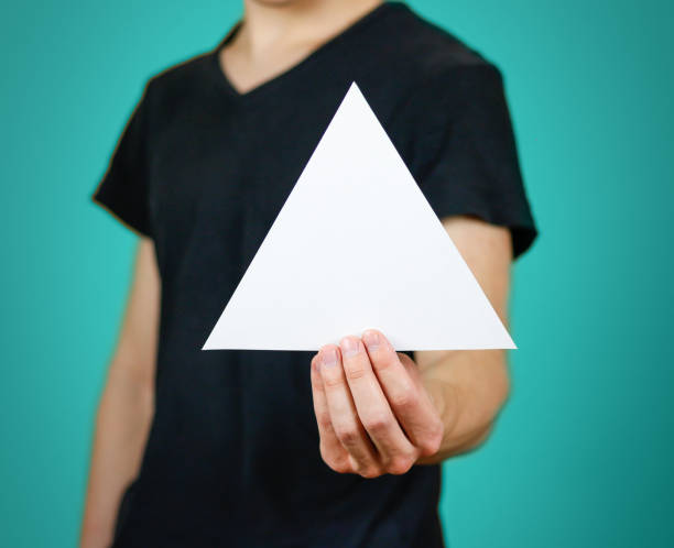 istock Man showing blank white triangular flyer brochure booklet. Leaflet presentation. Pamphlet hold hands. Man show clear offset paper. Sheet template. Booklet design sheet display read first person 669541680