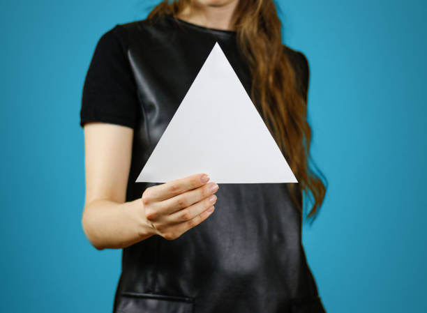 istock Girl showing blank white triangular flyer brochure booklet. Leaflet presentation. Pamphlet hold hands. Woman show clear offset paper. Sheet template. Booklet design sheet display read first person 669541740