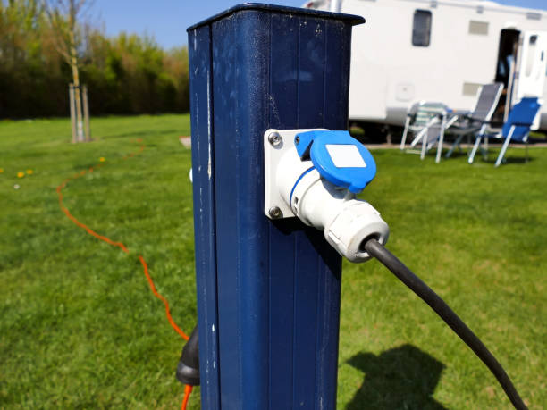 AC power sockets at a camping site, Full service campground electricity AC power sockets at a camping site, Full service campground electricity with camper motor home in background hook of holland stock pictures, royalty-free photos & images
