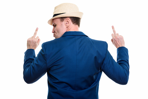Back view of mature businessman showing his middle finger with both hands horizontal shot