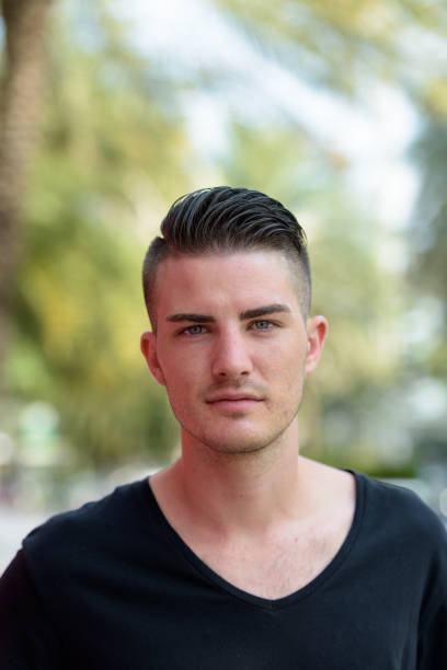 istock Young handsome man looking at camera in the parking lot 669555548