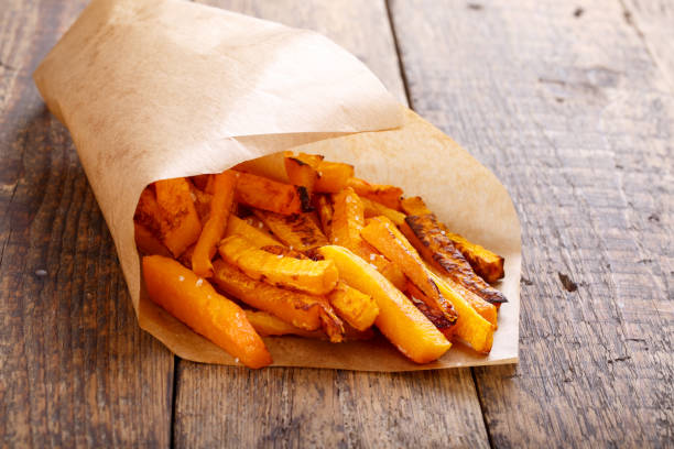 istock Baked butternut squash fries with sea salt. Pumpkin chips. 669555558