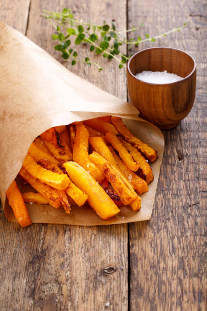 istock Baked butternut squash fries with sea salt. Pumpkin chips. 669555562
