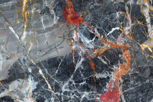 istock Gold, red, white patterned natural of dark gray marble background. 669558646