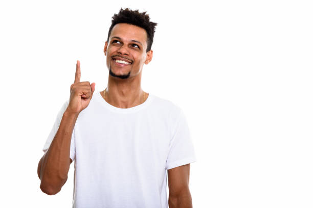 istock Thoughtful young happy African man smiling while pointing finger up 669559694