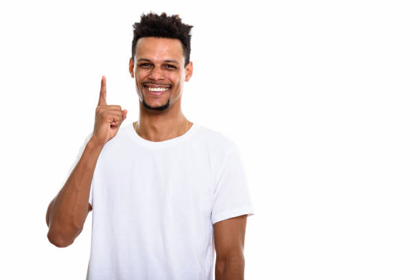 istock Studio shot of young happy African man smiling while pointing finger up 669559750