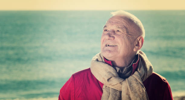 istock Mature man walking by sea 669560280
