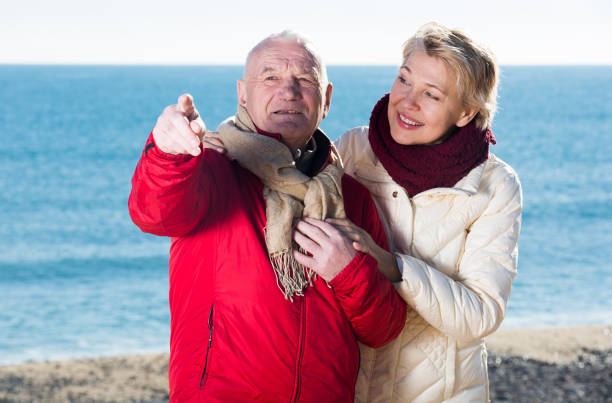 istock Mature couple pointing on beach 669560300
