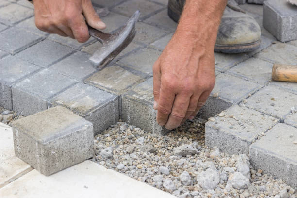 istock worker hands  laying concrete brick pavers 2 669560478
