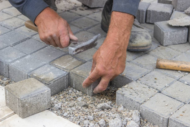 istock worker hands  laying concrete brick pavers 669560634