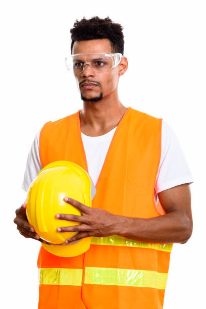 istock Young African man construction worker holding safety helmet while thinking 669560668