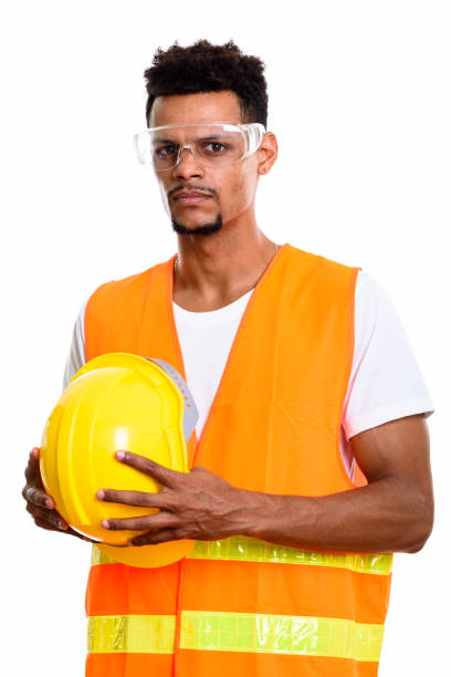 istock Young African man construction worker holding safety helmet with both hands 669560670