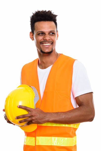 istock Thoughtful happy African man construction worker smiling while holding safety helmet 669560676