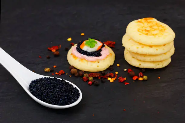 Lumpfish caviar and Homemade pancake canape on slate stone plate for finger food party