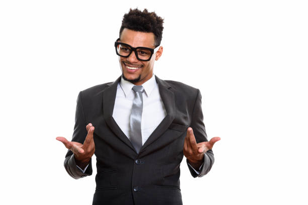 istock Young happy African businessman smiling while looking confused 669566314