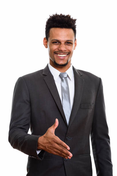 istock Young happy African businessman smiling while giving handshake 669566348