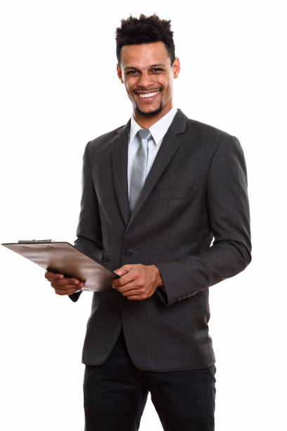 istock Young happy African businessman smiling while holding clipboard 669566398