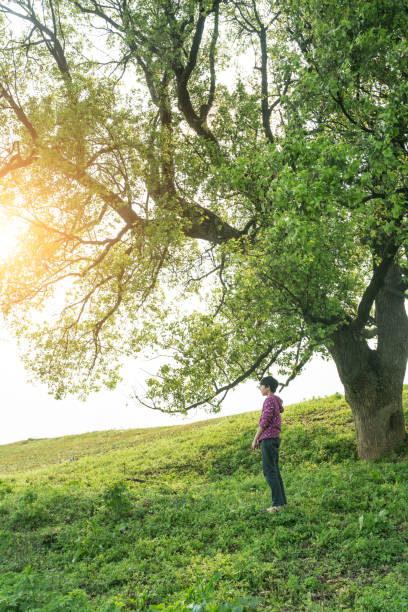istock asian girl standing on the grass field 669566402