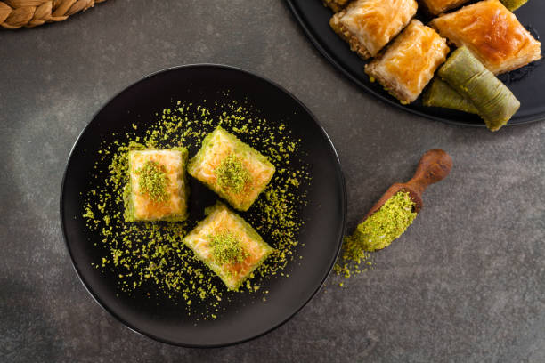 Baklava Baklava on black dish. food styling stock pictures, royalty-free photos & images