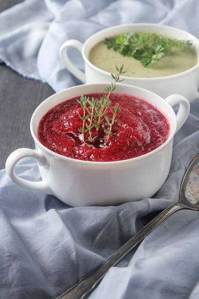 Traditional beetroot soup in white plate with Temyan, sour cream. Dark wooden background. free space text.