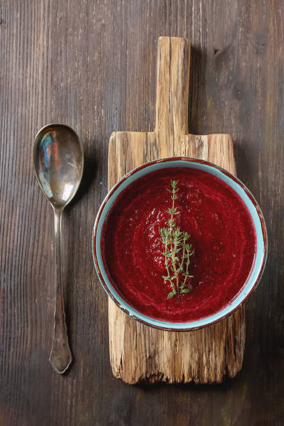 Traditional beetroot soup in a blue plate with Temyan. Dark wood background. free space text. Top view.