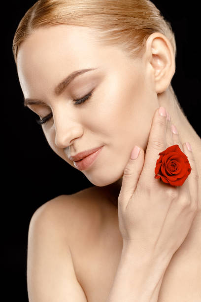 istock woman with red rose 669570004