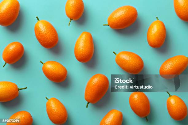 Flat Lay Pattern Of Fresh Kumquats On A Colorful Background Top View Stock Photo - Download Image Now