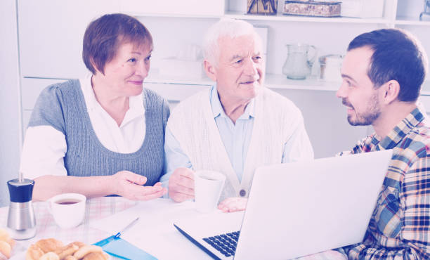 istock Aged couple signing agreement 669573584