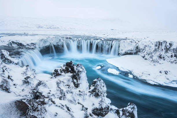 Beautiful winter Godafoss waterfall in Iceland, covered in snow, stock photo