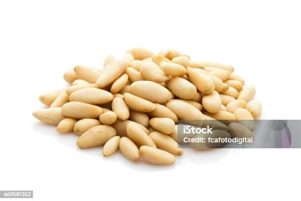 Pine Nuts Heap Isolated On White Background Stock Photo - Download Image Now - Pine Nut, Peeled, Abundance