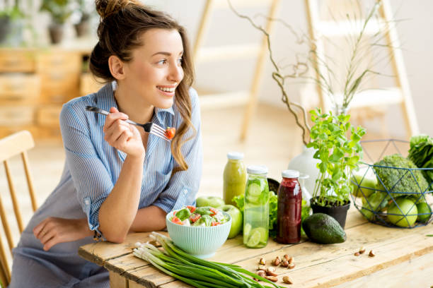 istock Woman eating healthy salad 669583932