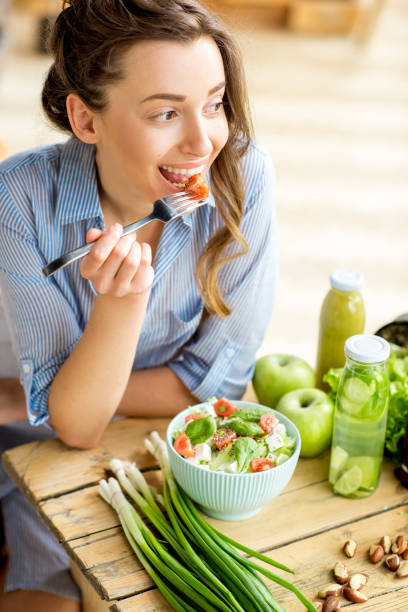 istock Woman eating healthy salad 669583956