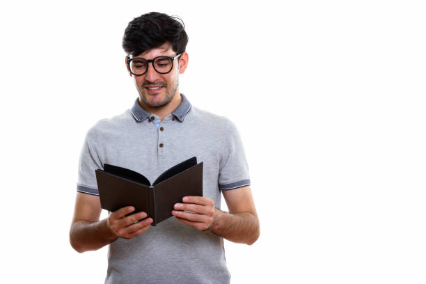 istock Studio shot of young happy Persian man smiling while reading book 669587944