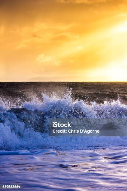 Waves Crash Onto The Beach At Hengistbury Head In A Dramatic Winter Storm Stock Photo - Download Image Now