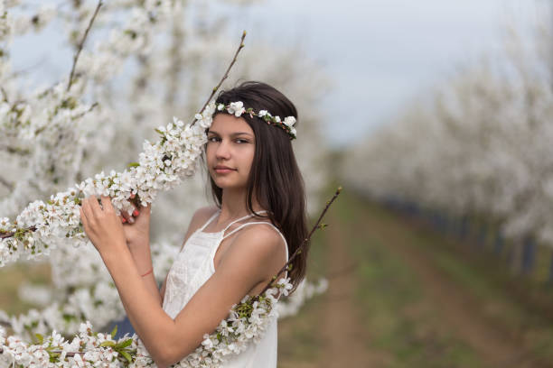 young bridal between almond blossoms, very creative vintage editing and added noise, selective focus