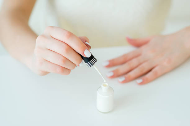 istock Pretty girl polishing her nails 669596998