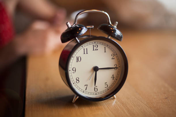 istock Vintage alarm clock on wood 669597426
