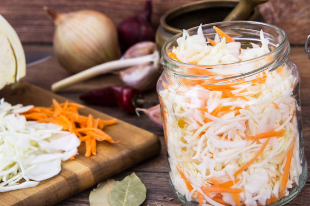 istock Sauerkraut with carrots in glass jar 669603990