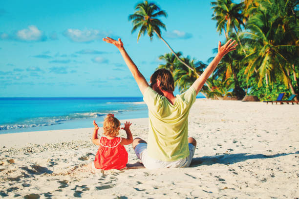 istock father and little daughter play at beach 669613702