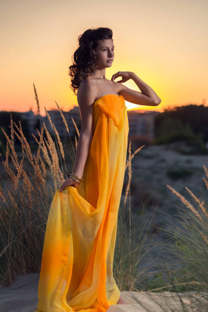 istock Beautiful girl on the beach at sunset 669614704
