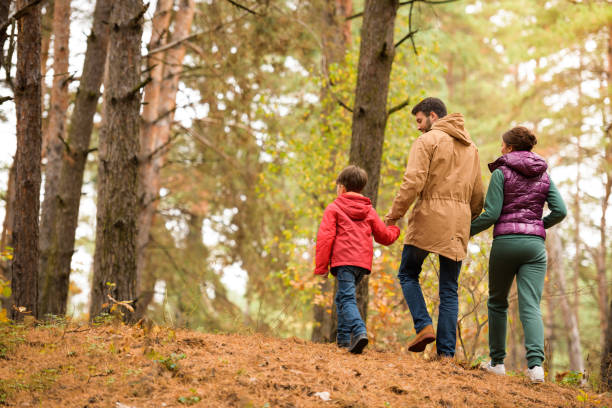 istock Family walking in autumn forest 669617466