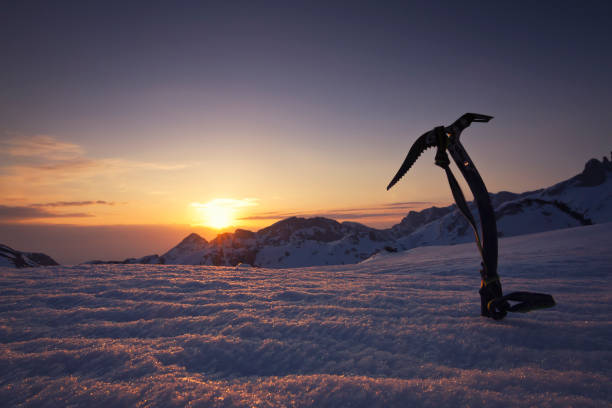 Beautiful mountain sunset with ice axe in the background stock photo