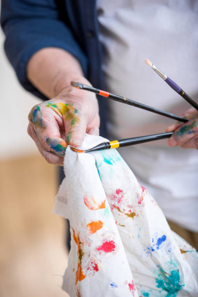 istock partial view of man cleaning paint brushes in hands 669621704