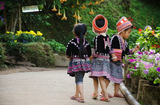 Children Ethnic Hmong wear costume traditional and playing with friends at Doi Pui Tribal Village and National Park on December 28, 2016 in Chiang Mai, Thailand.