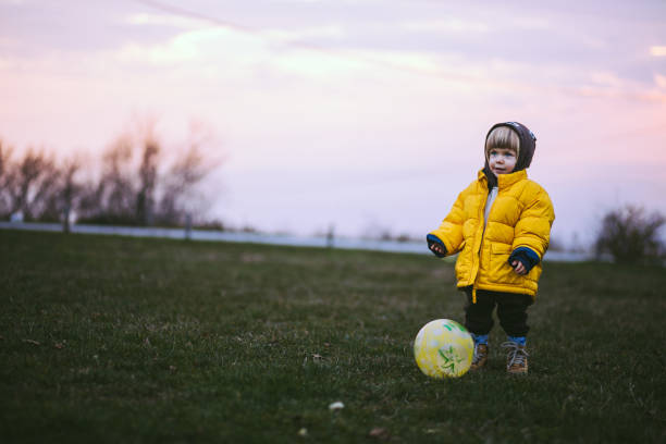 istock Pretty Kid Playing Soccer On Autumn Day 669631476