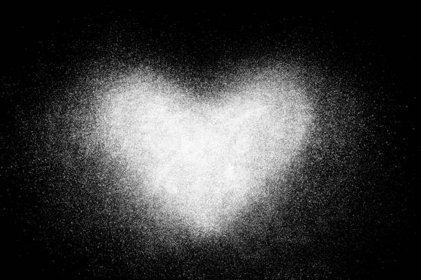 Freeze motion of  white powder isolated on black dark background Freeze motion of  white powder isolated on black dark background. Abstract design of dust cloud. Particles heart shaped explosion screensaver, wallpaper with copy space. Love, passion, care concept photoshop texture stock pictures, royalty-free photos & images