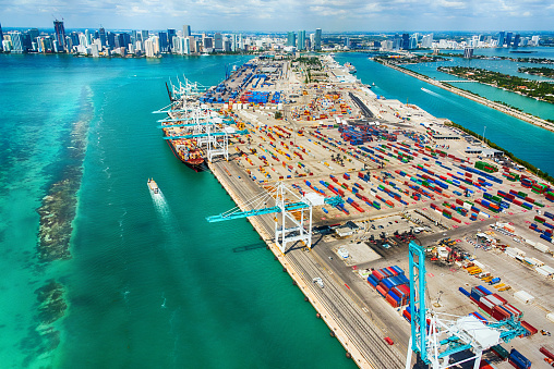 The large seaport of Miami Florida in wide angle on the Biscayne Bay with the skyline of the city in the background.
