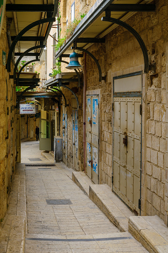 Nazareth: An alley in the old city, with local businesses and a local, in Nazareth, Israel