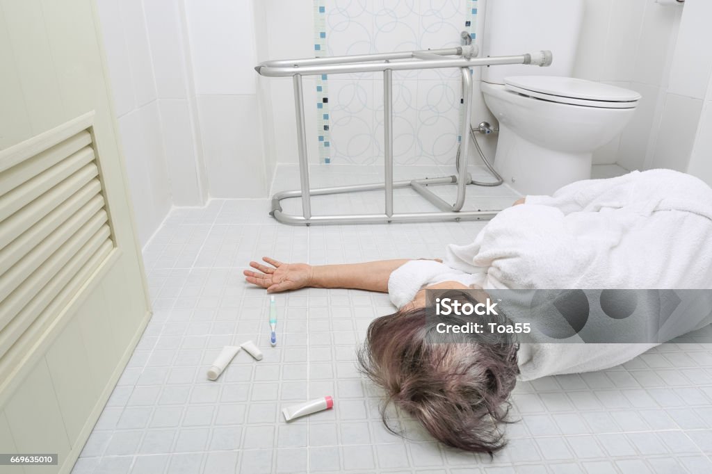 Elderly woman falling in bathroom Elderly woman falling in bathroom because slippery surfaces Falling Stock Photo